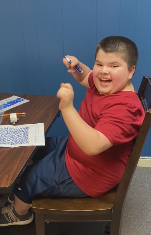 Child smiling after completing an activity