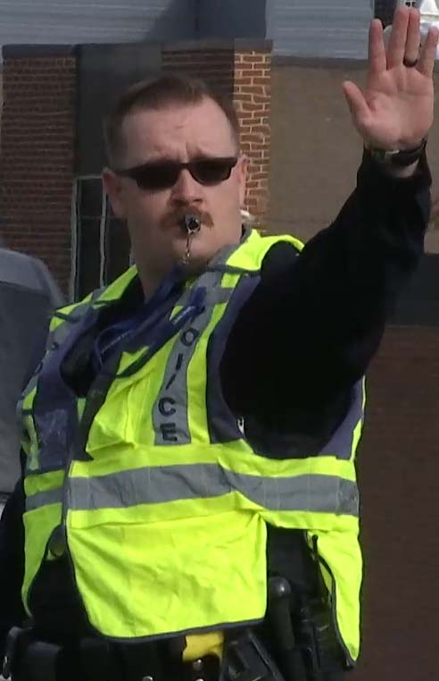 Crossing guard signaling for cars to stop.